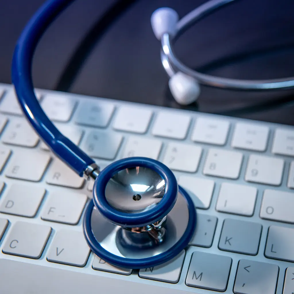 Medical science technology concept. Blue stethoscope on white modern keyboard on doctor desk. Health and wellness background. Global healthcare business. Computer antivirus protection
