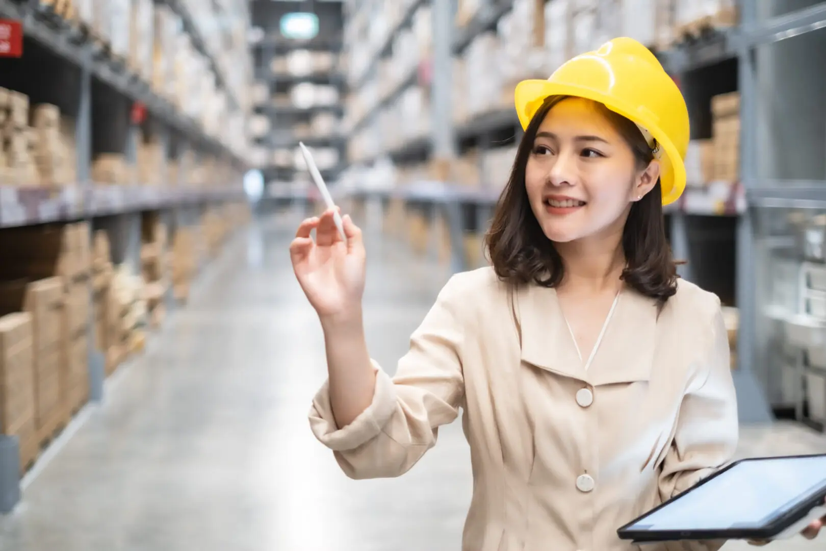 Pretty worker checking stock in the warehouse. Asian beautiful young woman worker of furniture store.Businesswoman using tablet in distribution stock.
